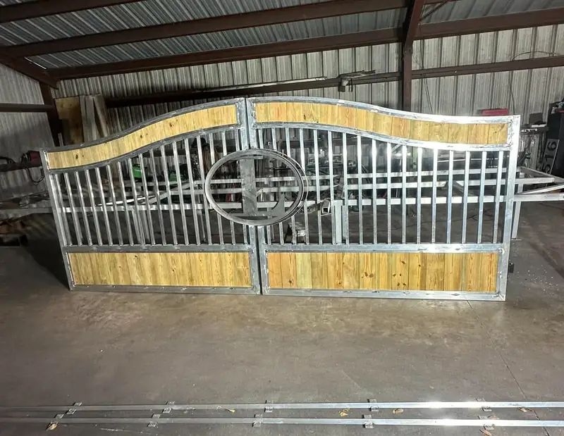 Aluminum double gate with wood panels being finished in the shop